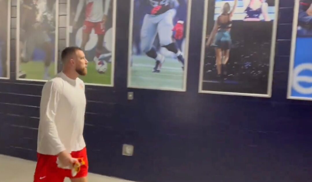 Travis Kelce was spotted staring at the Taylor Swift poster at Gillette Stadium, and fans are loving it