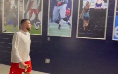 Travis Kelce was spotted staring at the Taylor Swift poster at Gillette Stadium, and fans are loving it